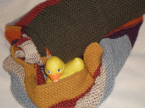 Yes, that is a rubber duck sitting in a nest made of a homemade Doctor Who scarf.