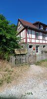 "timbered house surrounded by fence and tree" 