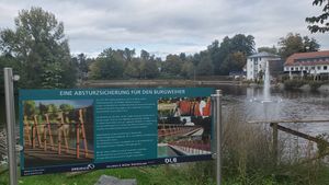 "lake with fountains; info sign in the front"