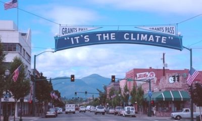 "It's the Climate" -- A local landmark and civic slogan over the main street in downtown Grants Pass, Oregon.