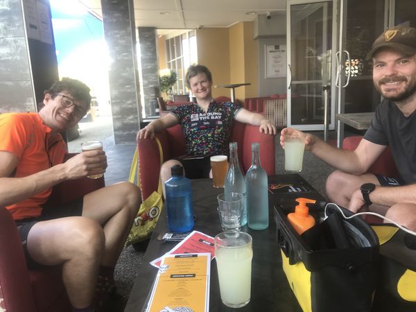 Photo of Cam, Patrick and John sitting at a pub with drinks