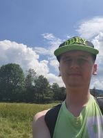"against-the-sun selfie of myself, wearing cap"