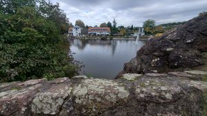 "looking at lake; tree on left, houses in background"